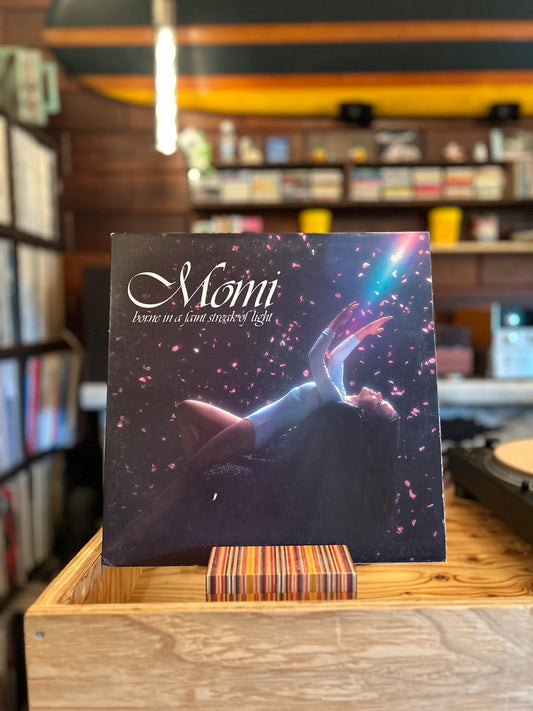 MOMI / BORNE IN A FAINT STREAK OF LIGHT